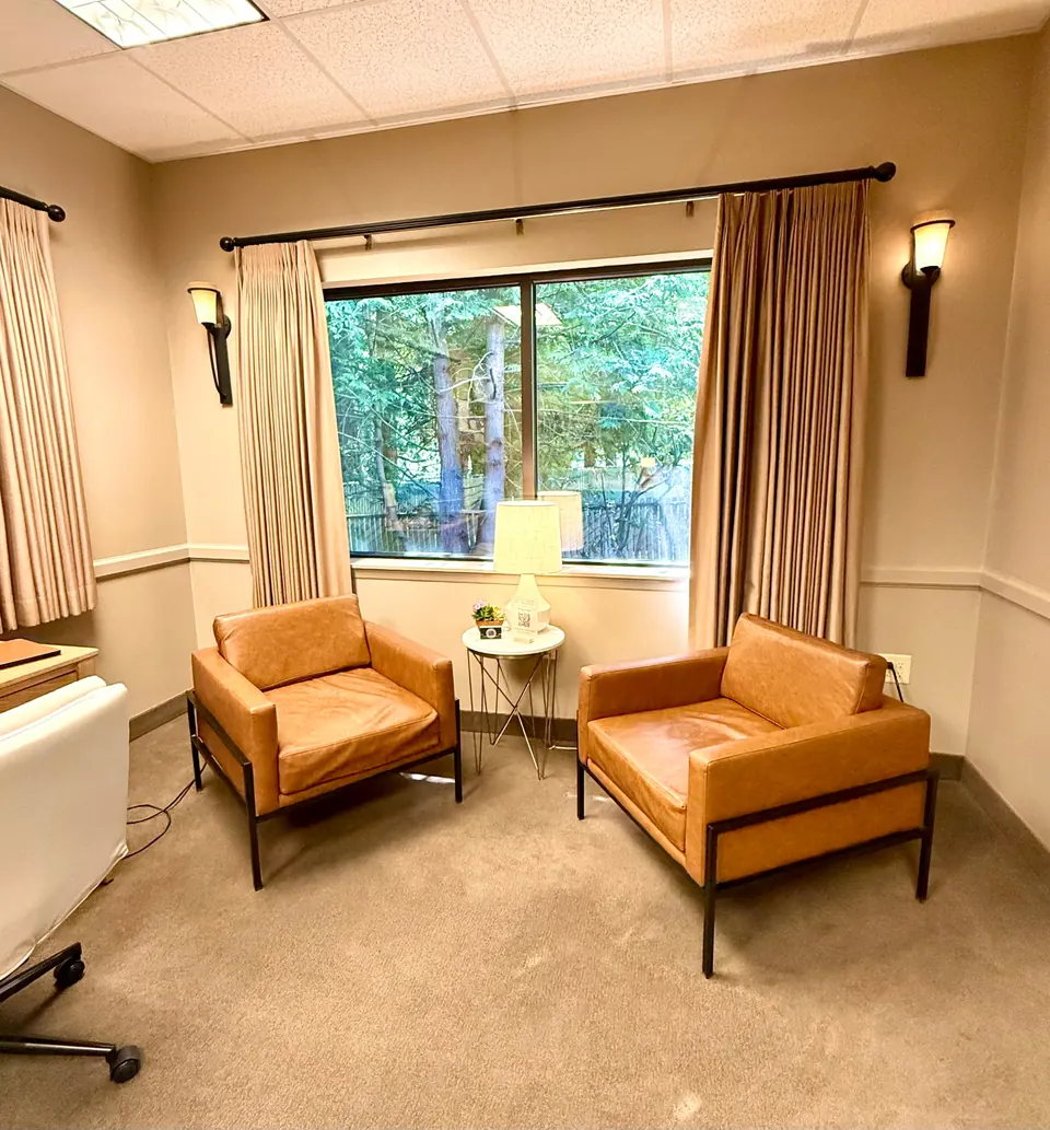 A warm, private consultation room with comfortable seating at Functional Wellness & Aesthetics